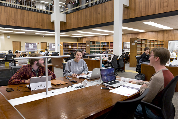 LSU Law students studying at a table in the Law Library.