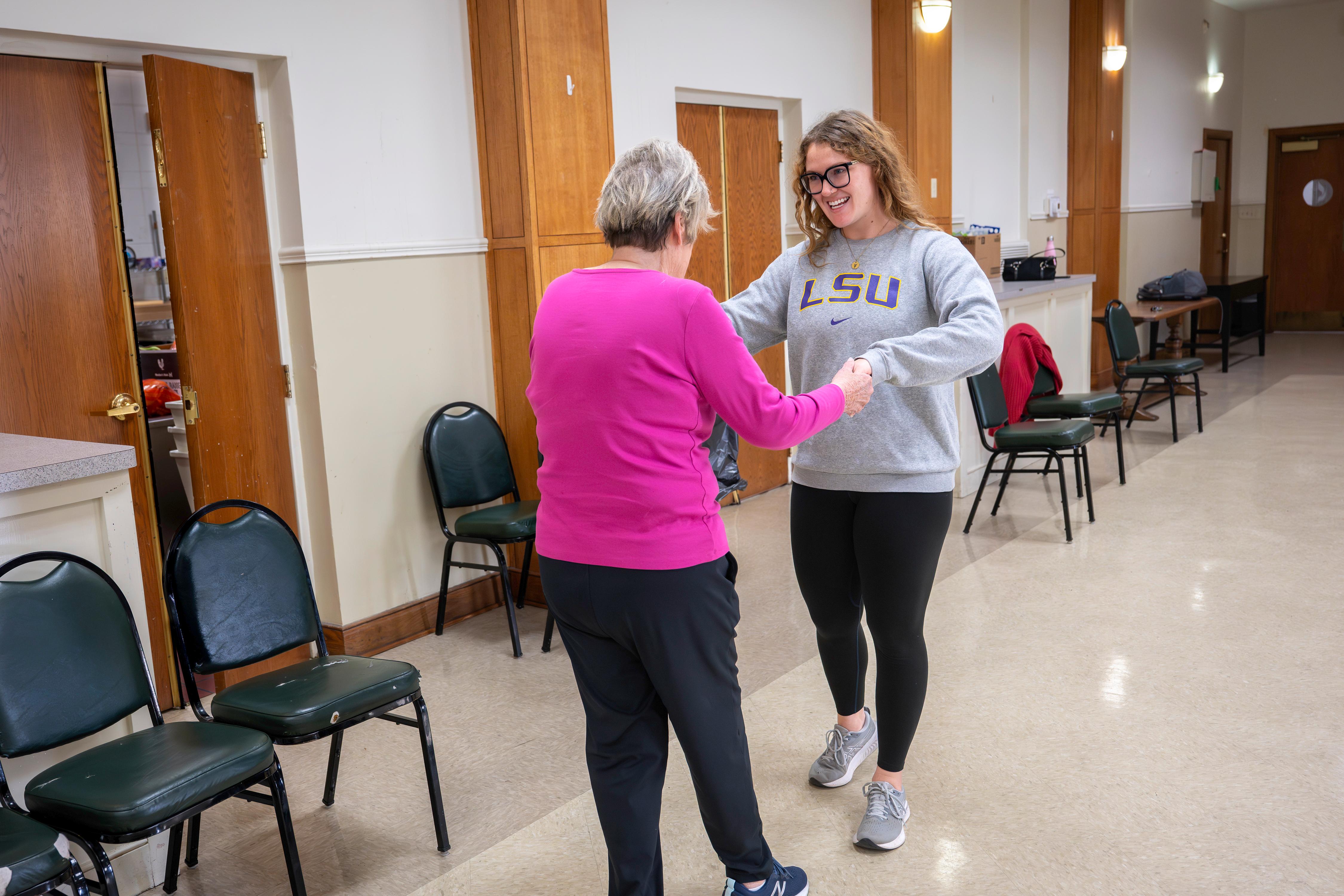 Grad student Taylor Gauss leads a modified tai chi class