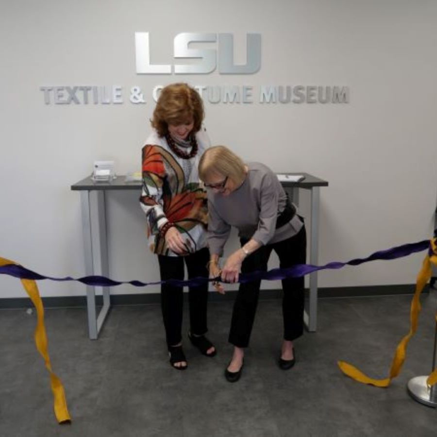 Two women cutting a ribbon