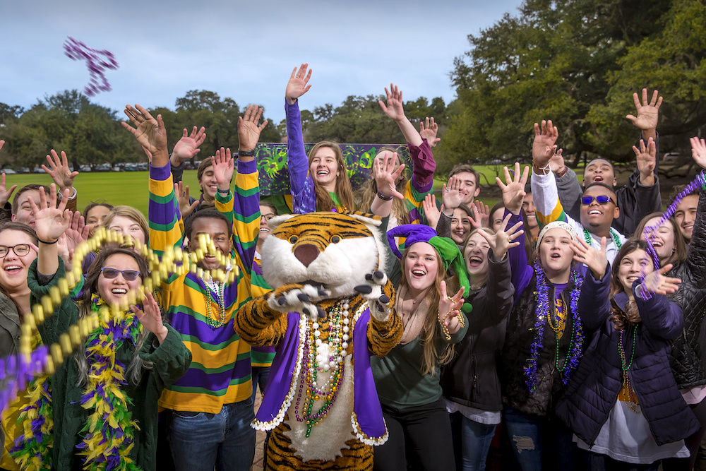 LSU students and mascot Mike the Tiger catch Mardi Gras beads