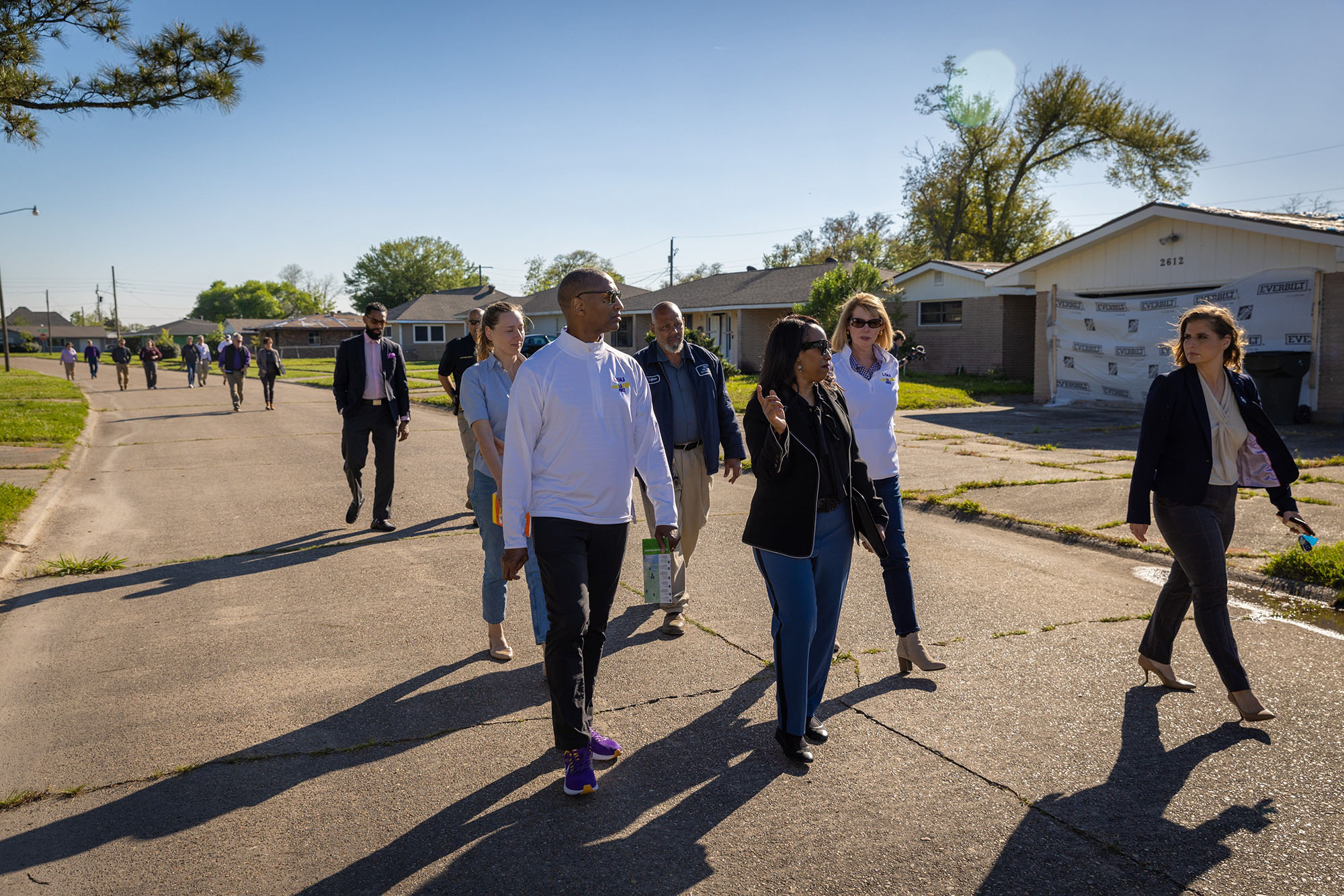 President Tate and group tour a storm-damaged neighborhood