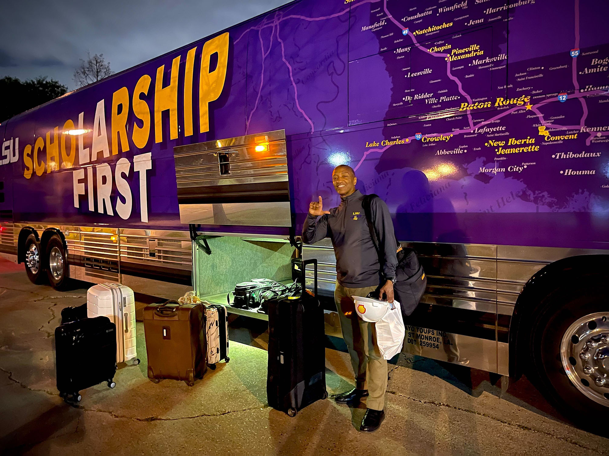 President Tate loads luggage onto the tour bus