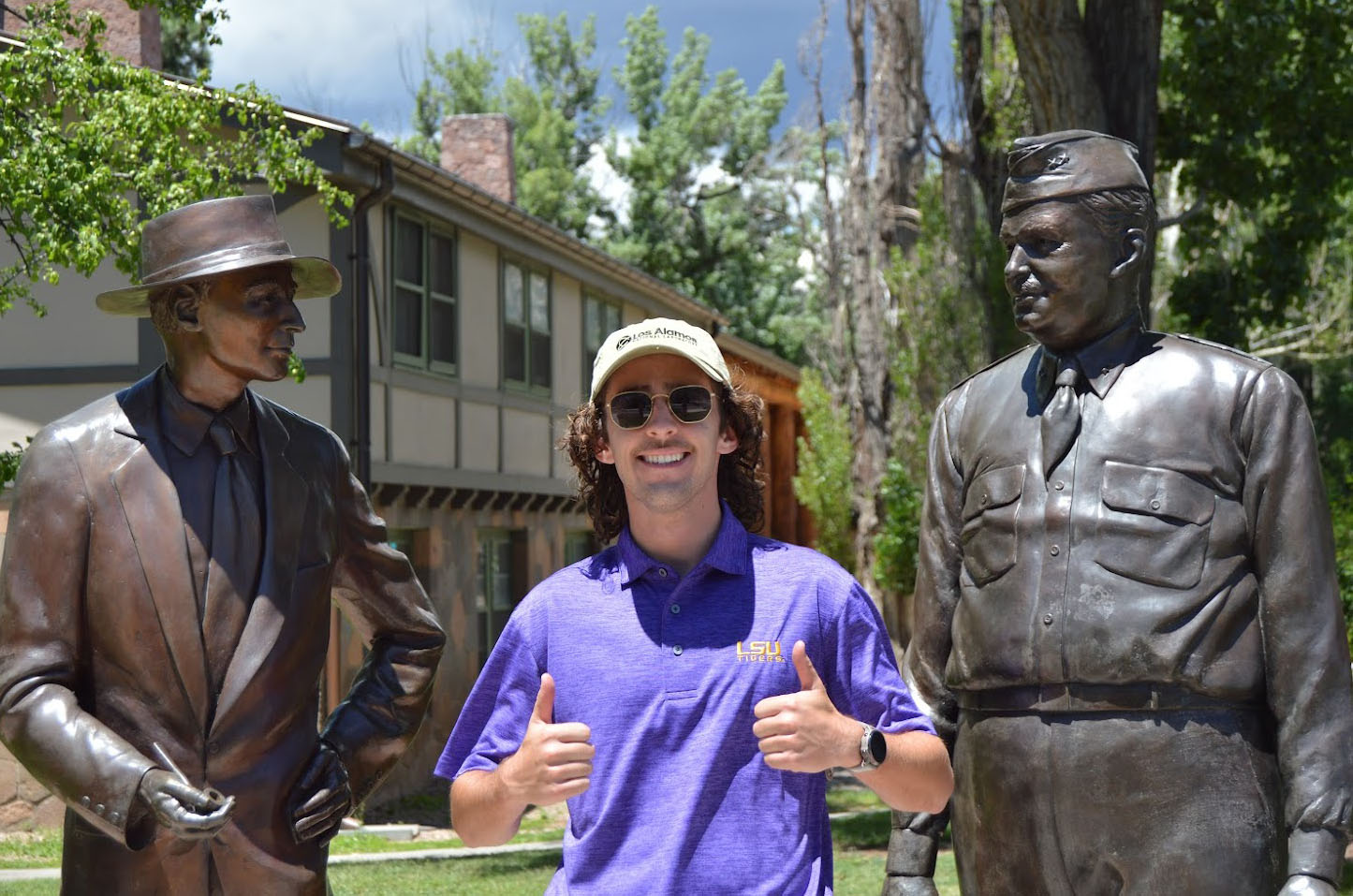 Courville posing with statues 