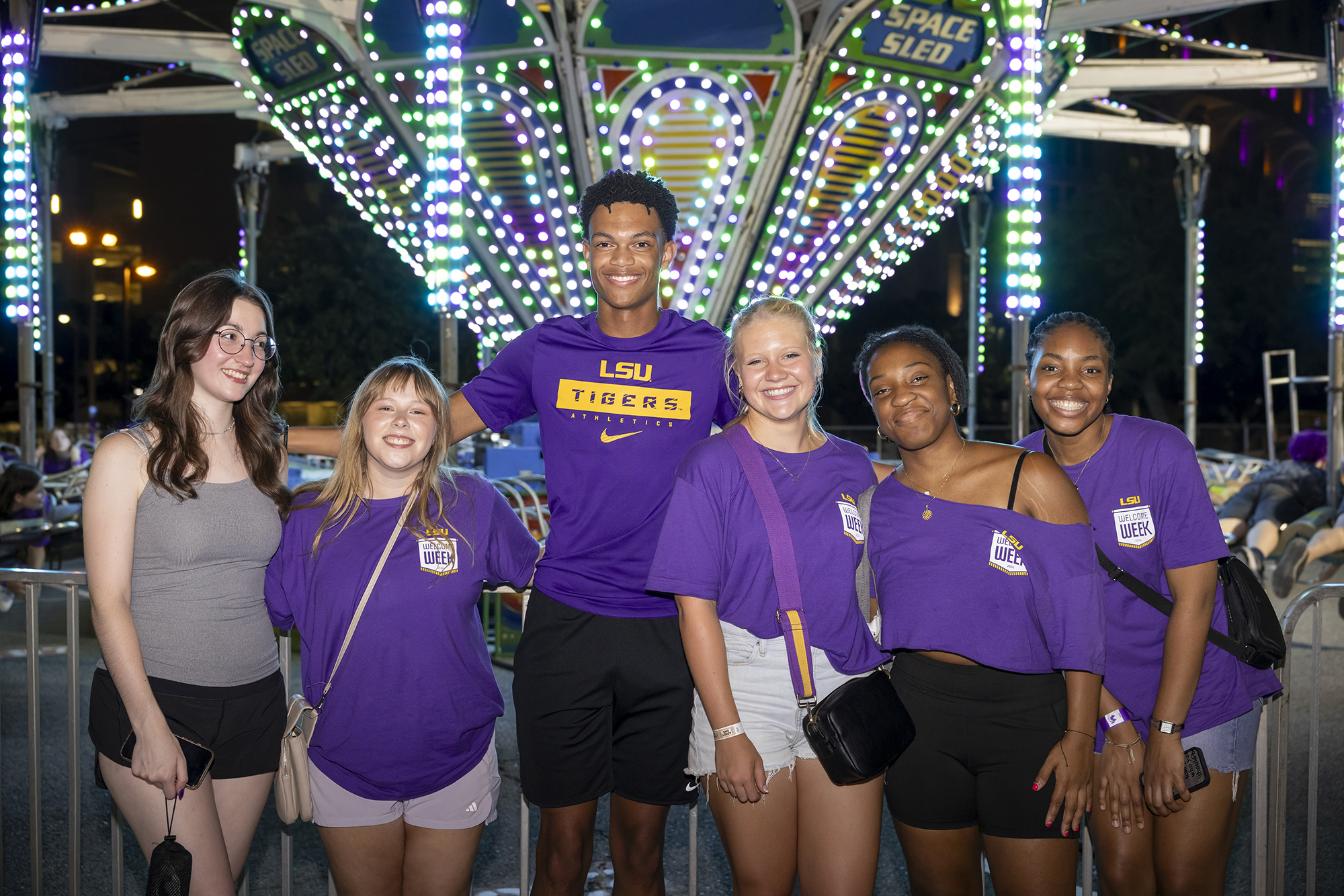 Students pose in front of caroussel during LSU's Welcome Week