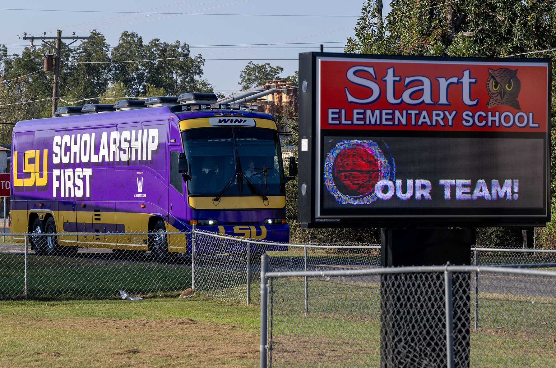 LSU Scholarship First tour bus parked near school sign at Start Elementary