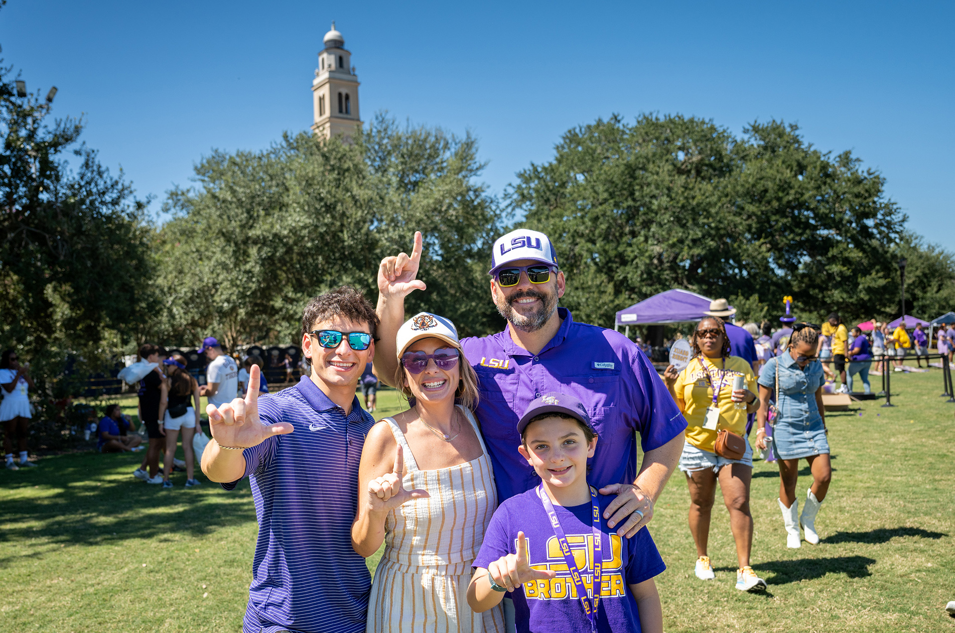 Family smiles for group photo on LSU Parade Grounds