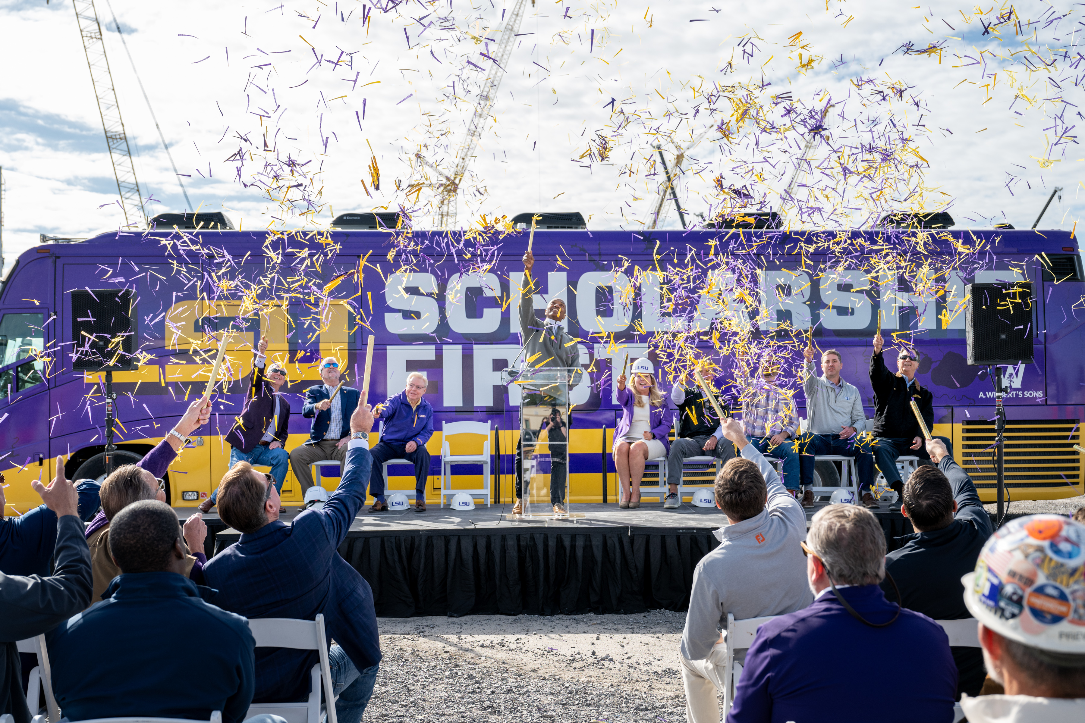 Celebration with confetti in front of the Scholarship First bus