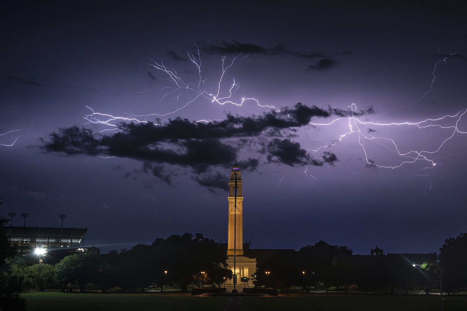 Lightening in darkened sky behind LSU's Memorial Tower