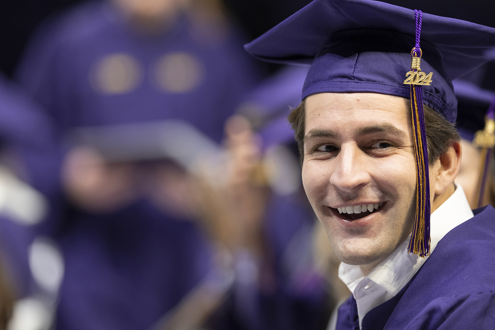 Happy graduate smiles during commencement