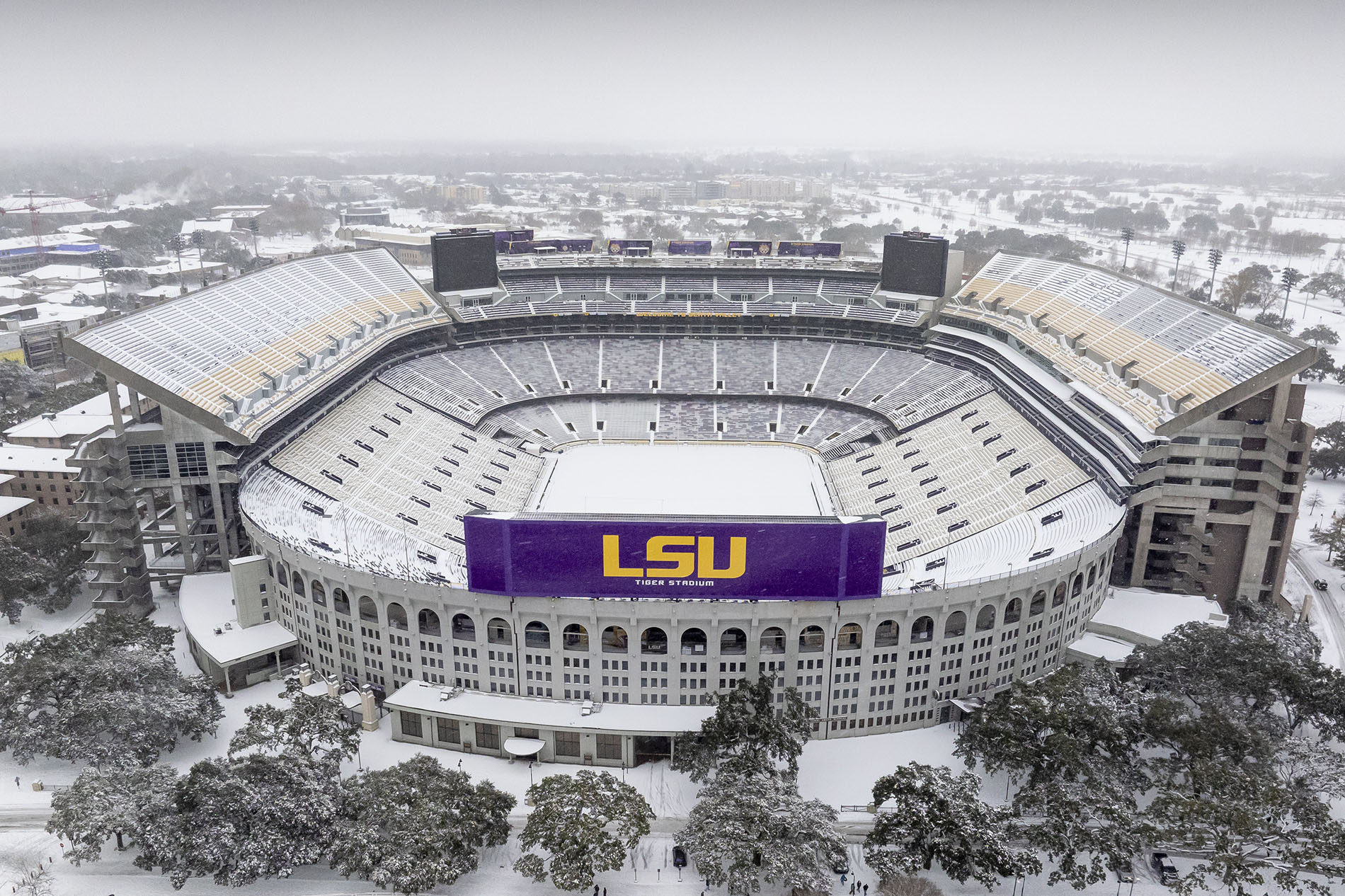 Aerial view of LSU's Tiger Stadium blanketed in snow.