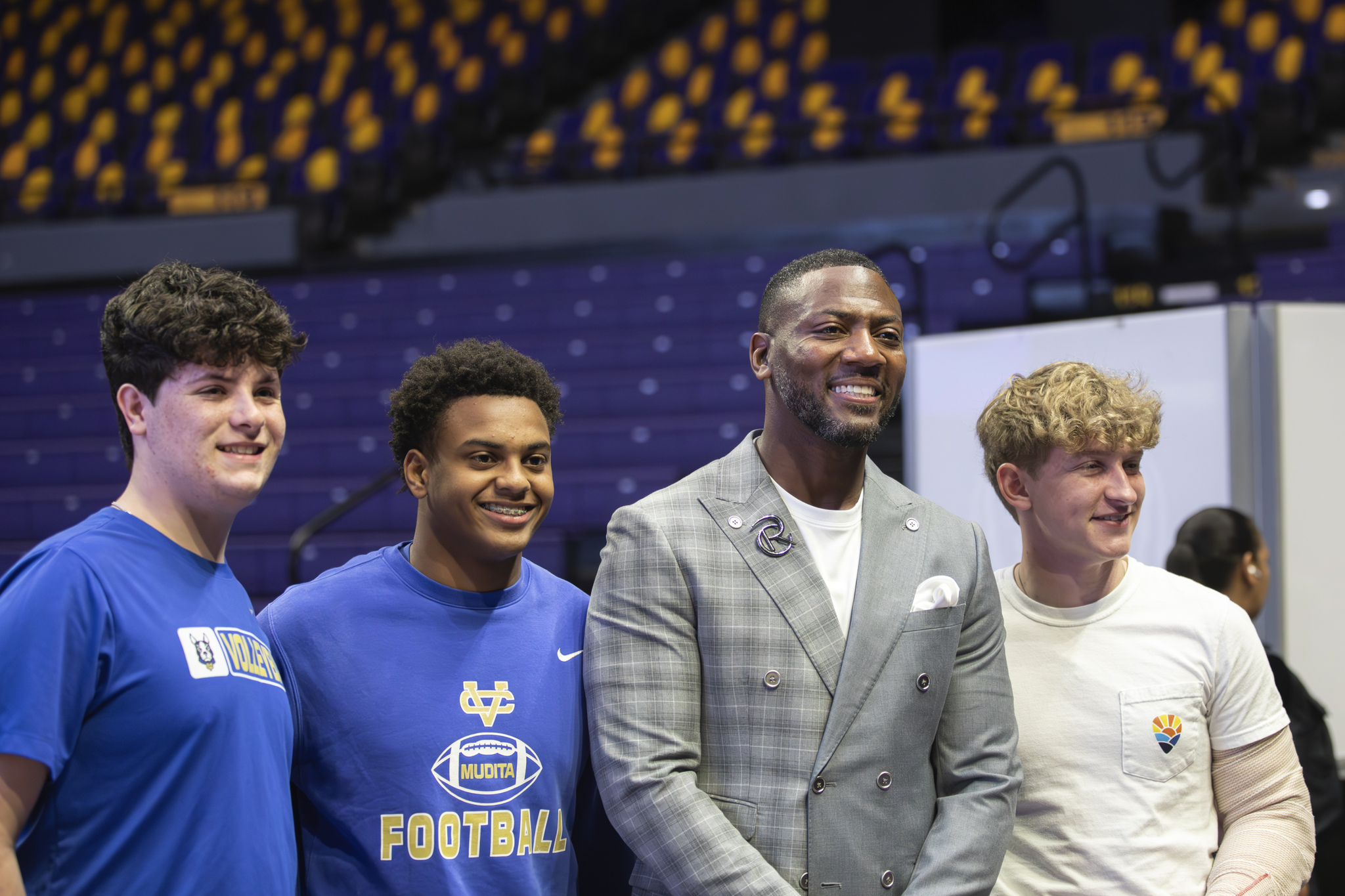 Ryan Clark posing for photos with three students