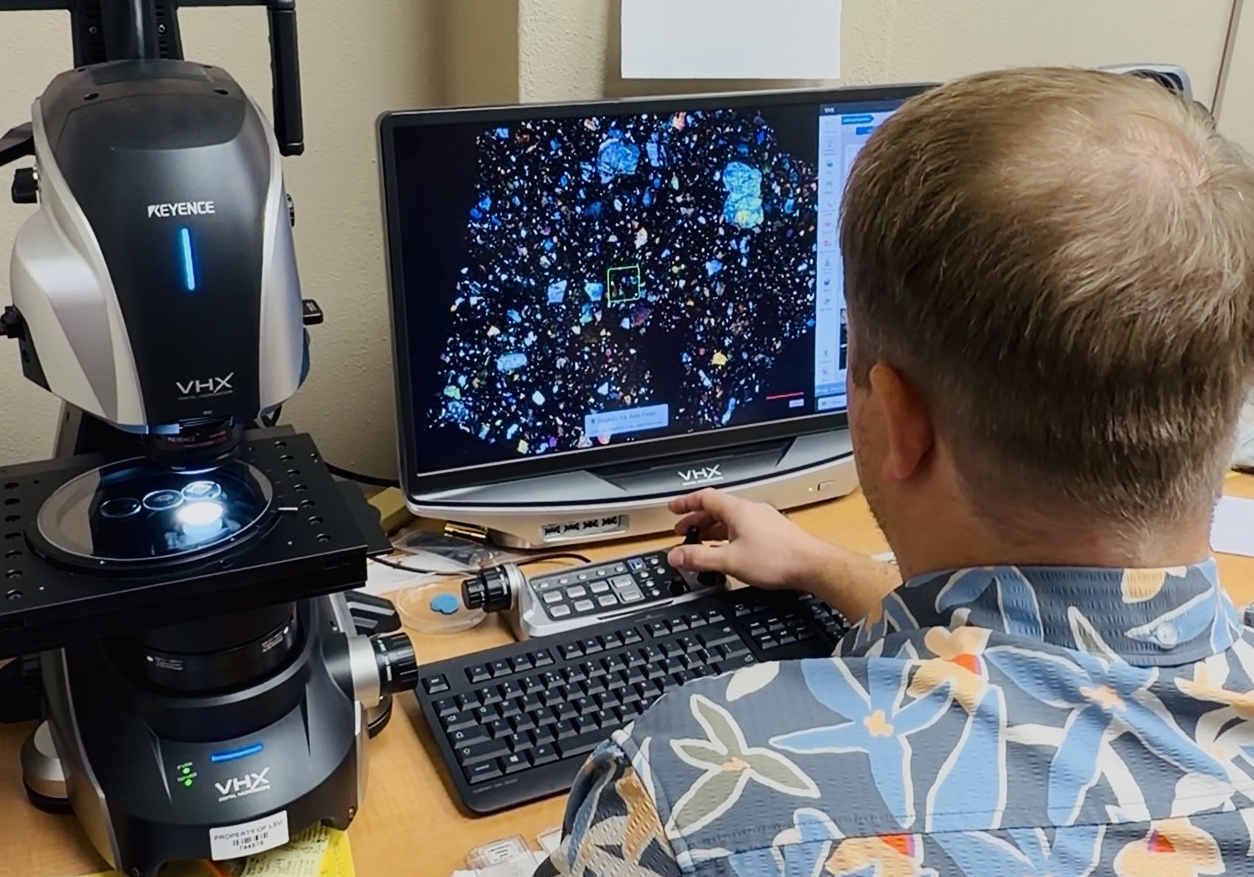 Matthew Loocke looking at computer screen in lab.