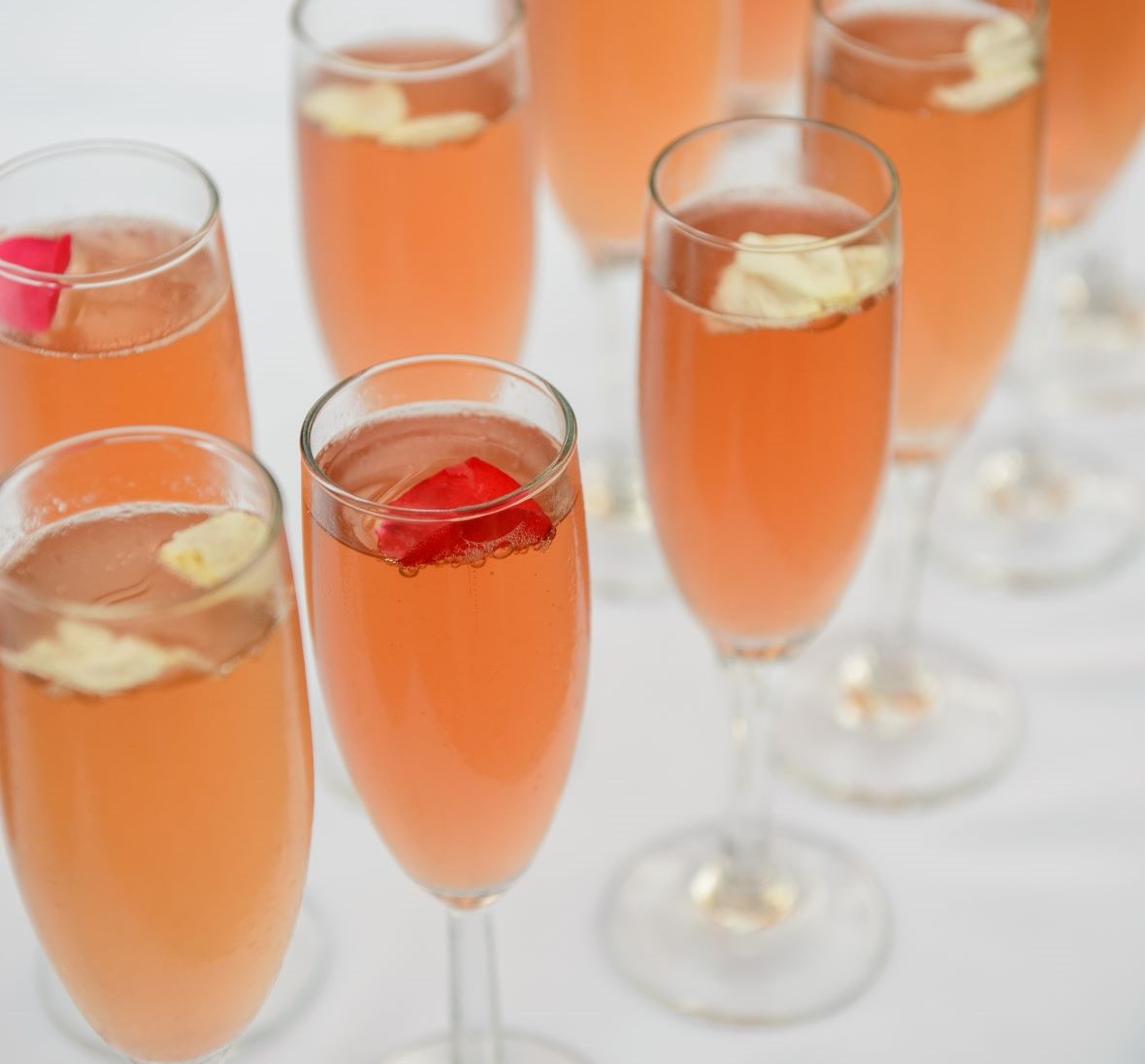 champagne flutes filled with pink cocktail