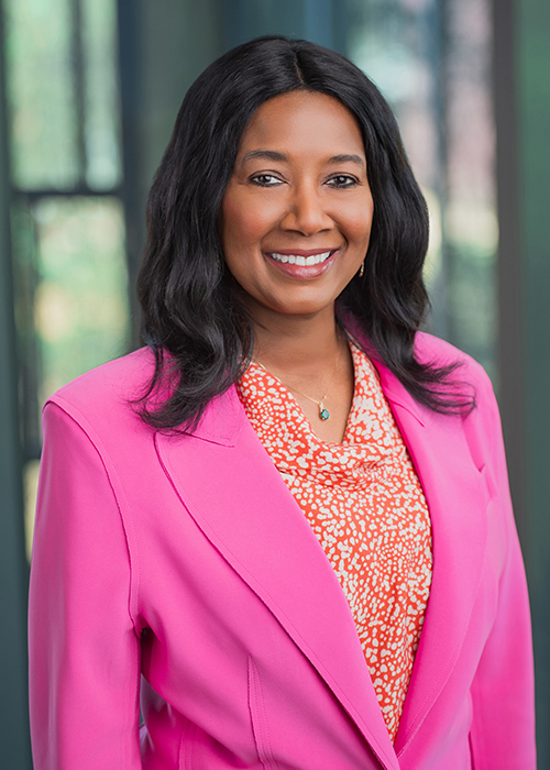 Angela Guidry wears a pink blazer in this photo taken in the Business Education Complex.