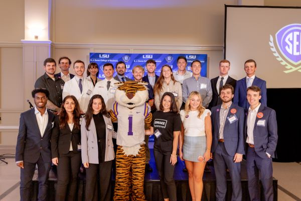Large group of people on a stage with LSU tiger mascot. 