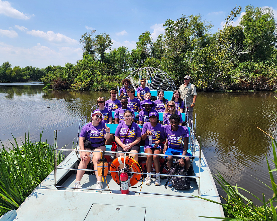 people in a blue airboat