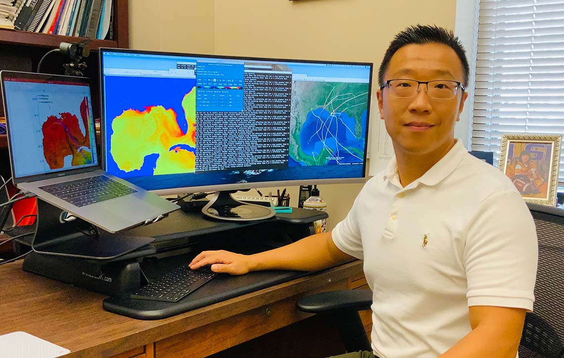 Z. George Xue sits in front of a coupled model.