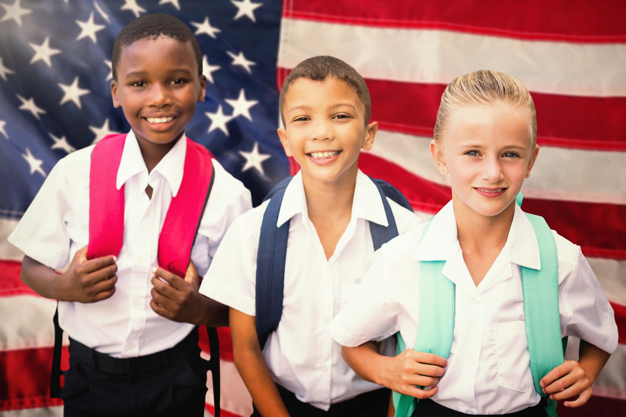 two male children and one female child wearing school uniforms and backpacks standing in front of the American Flag