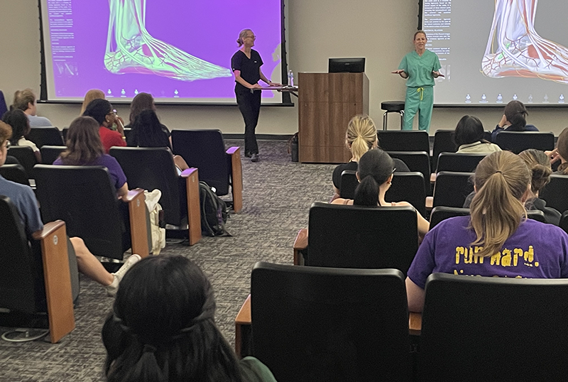 Photo of Melissa Thompson and Cate Richie lecturing to students