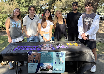 The students in the Homeless in Our Community class hosting a table in Free Speech ALley.