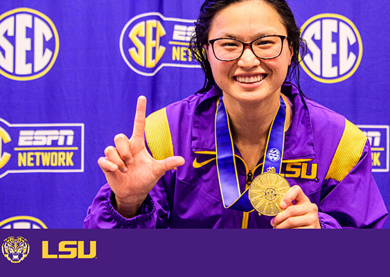 Photo of Maggie MacNeil iwith her medal in front of an SEC step and repeat.