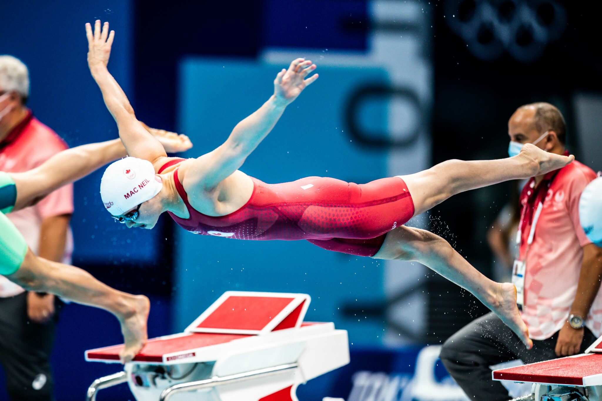 Maggie Mac Neil diving into a swimming pool