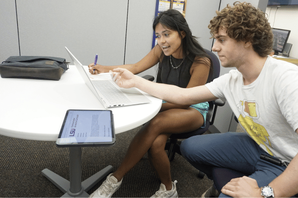 two students discussing a project at a table