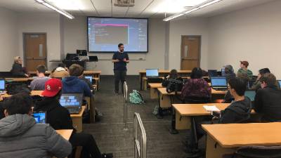 Man giving presentation to classroom of Developer Student Club members