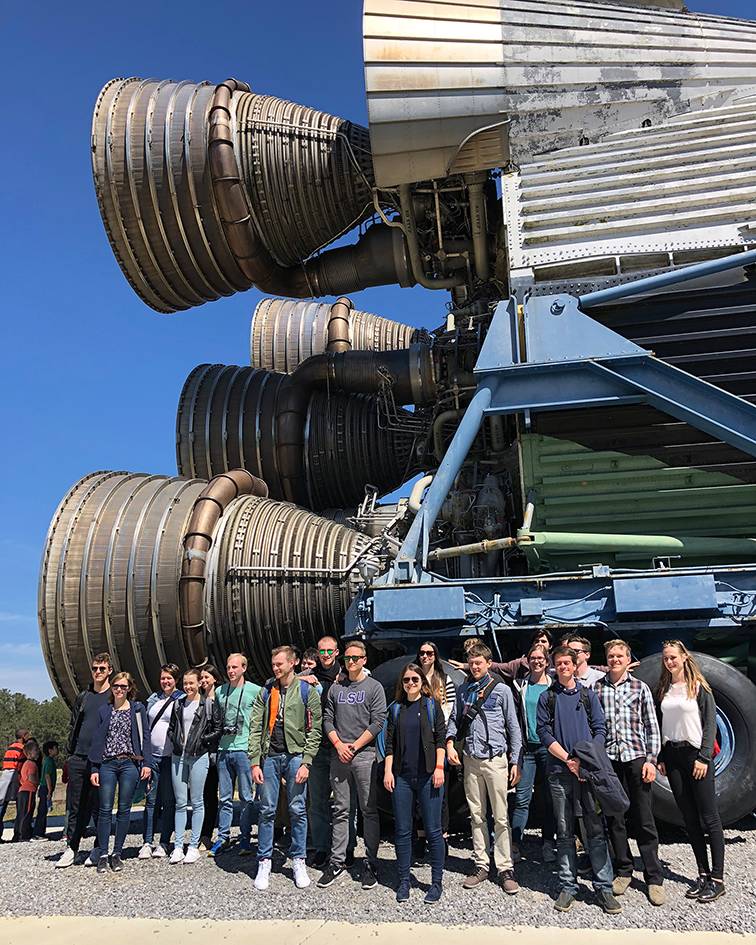 The German Fulbright students stand in front of a Saturn V rocket during their visit to NASA’s Stennis Space Center in Hancock County, Miss.