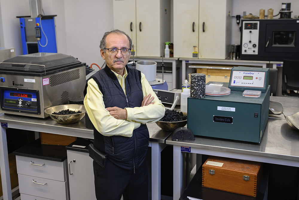 Louay Mohammed in front of lab equipment