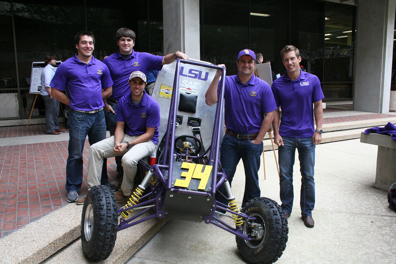Five male students with LSU polos posing with the LSU ME Mini Baja race vehicle