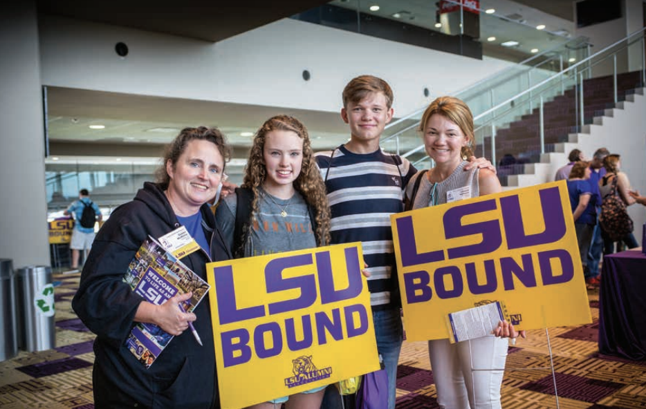 family holding LSU bound sign