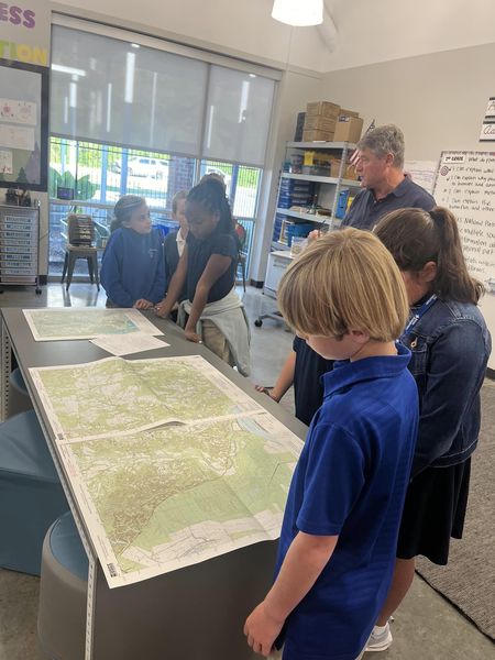 Dr. Leitner discusses maps with the students