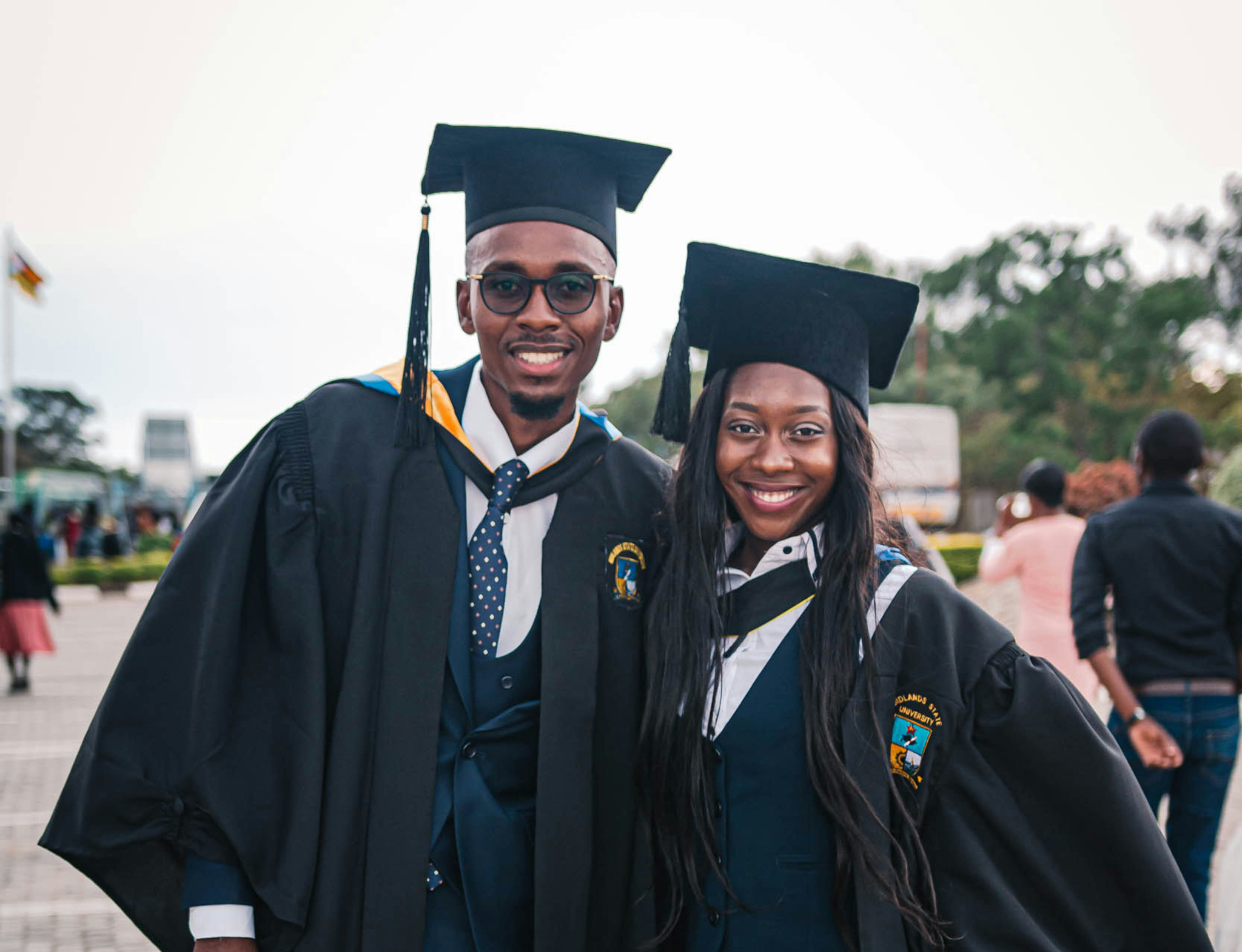 two students in graduation regalia