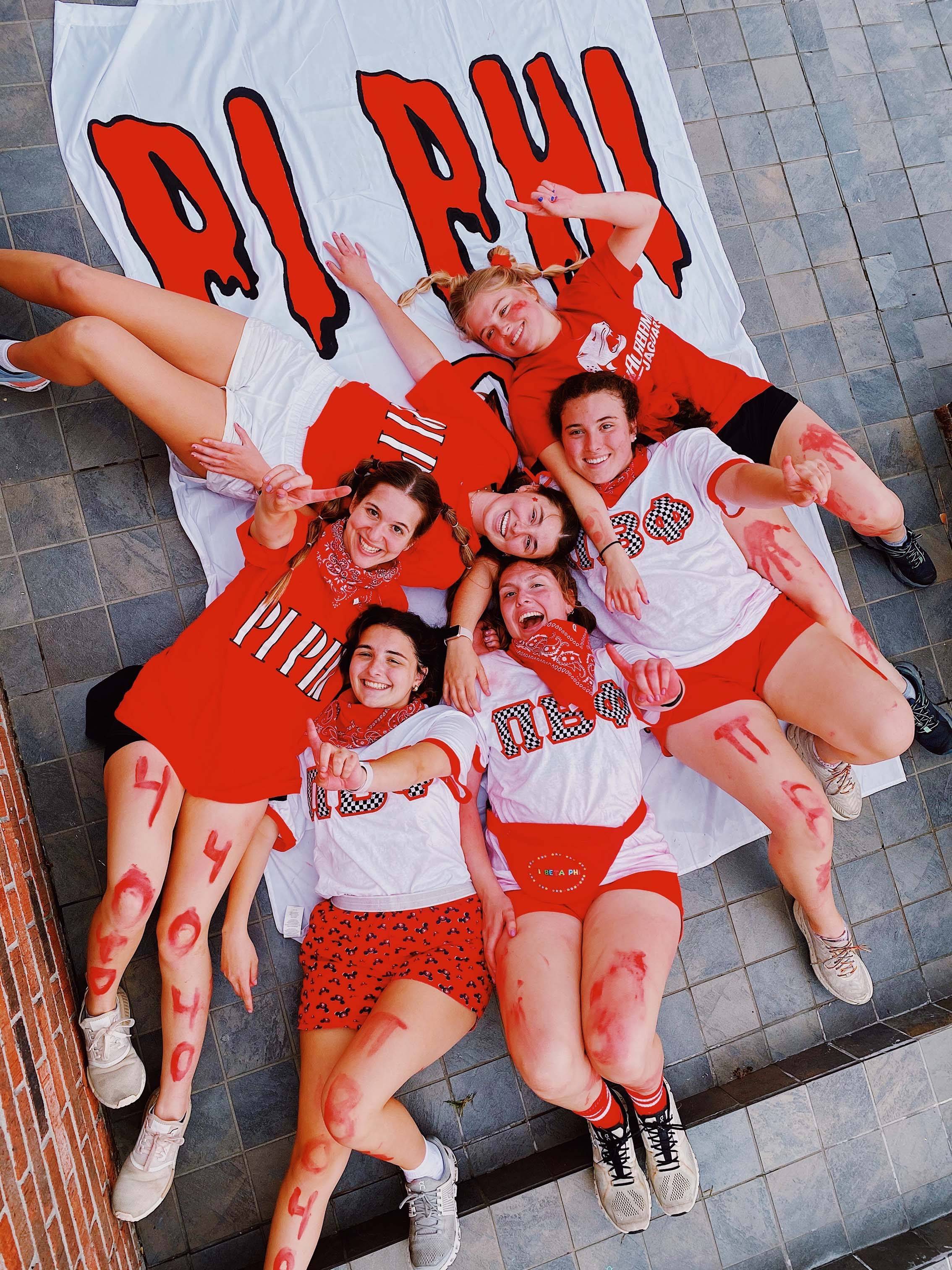 pi phi members in red shirts and face paint