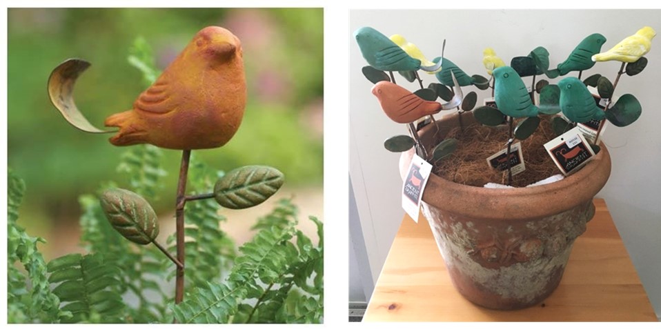 terra cotta bird pick in pot and pot with assorted ceramic bird picks