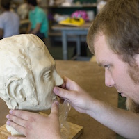 Student works on sculpture.