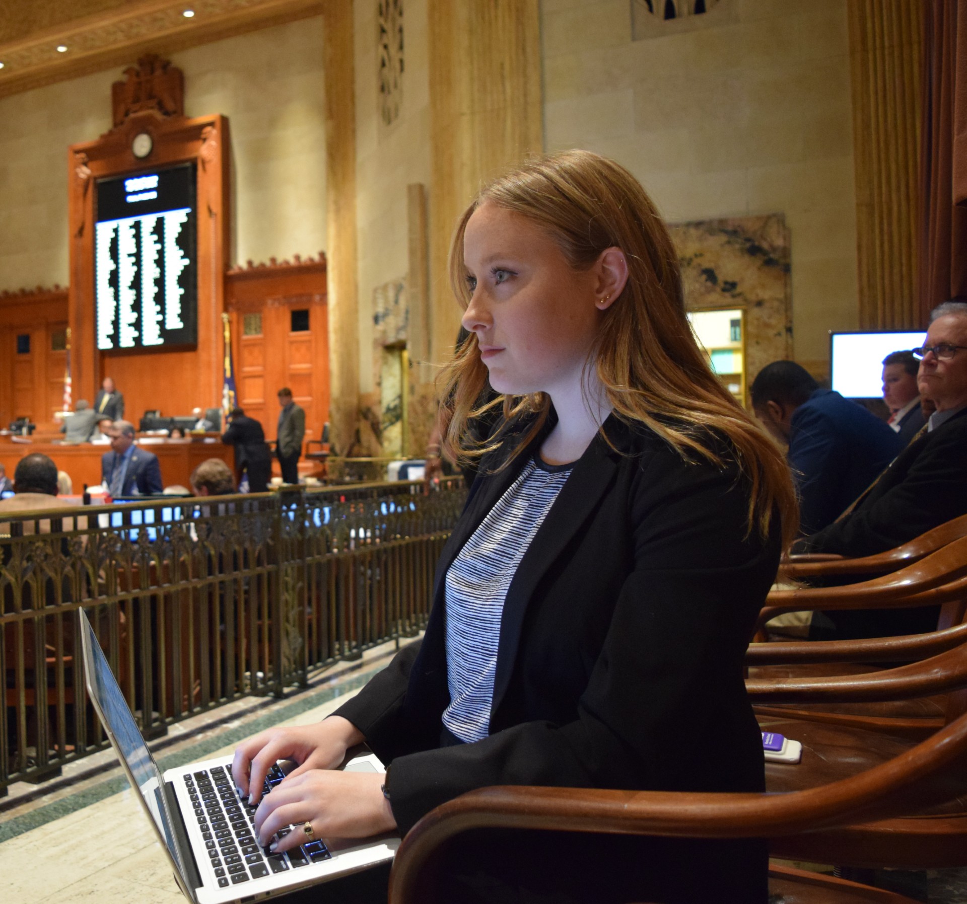 Student taking notes on laptop