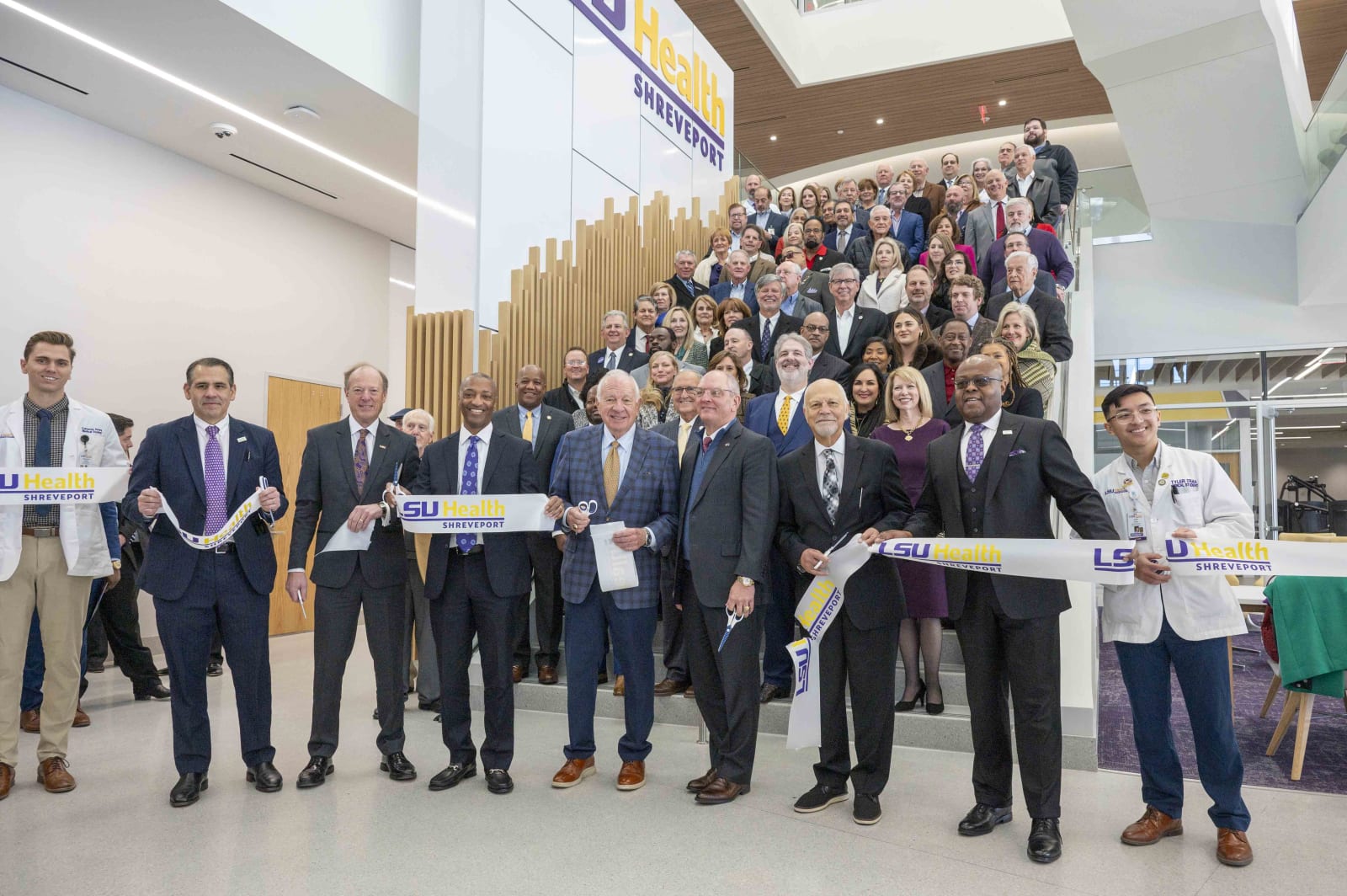 LSU President Tate, Gov. John Bel Edwards and others take part in a ribbon cutting inside the new medical education building