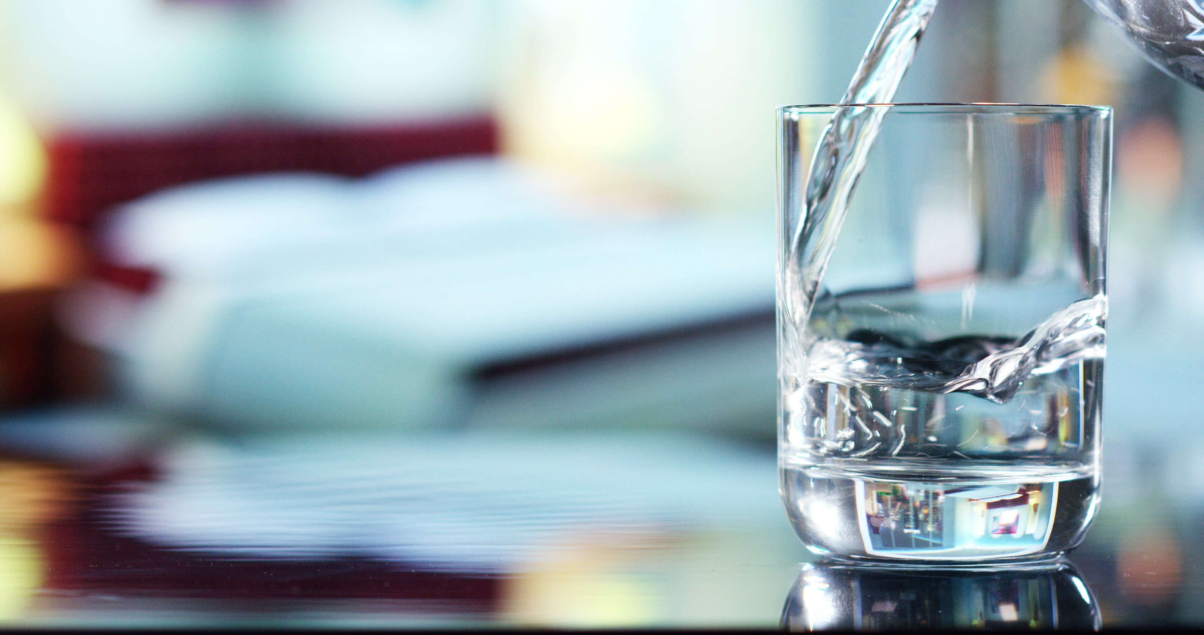 drinking water being poured into a glass