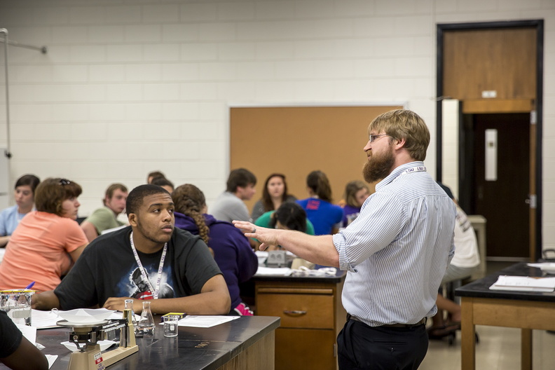 man speaking to students in science lab