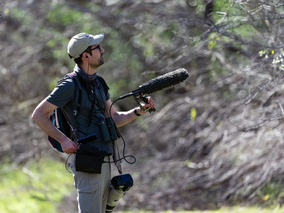 Dr. Andre Moncrieff recording birds in the field