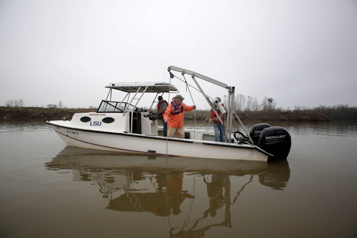 Professor Sam Bentley of LSU working on a boat on the Gulf of Mexico.