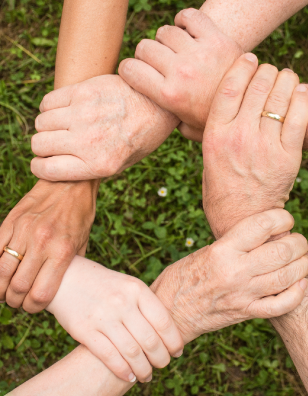 Photo of hands clasped together in support